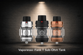Three Vaporesso iTank T Sub-Ohm Tanks in silver, black, and bronze finishes displayed under a spotlight against a brick wall background.